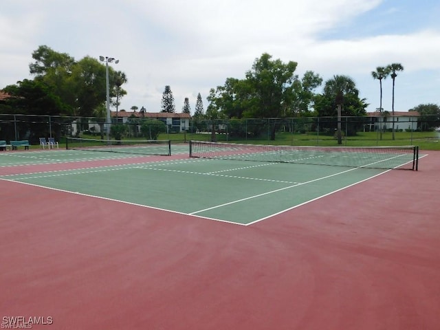 view of tennis court with basketball hoop