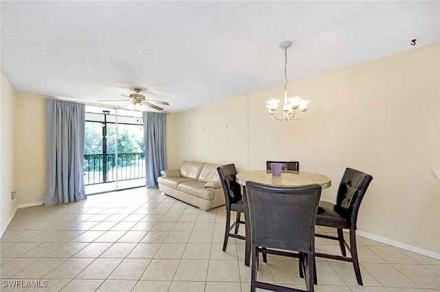 dining space with a textured ceiling, light tile patterned floors, and ceiling fan with notable chandelier