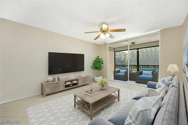 tiled living room featuring a textured ceiling, a wall of windows, and ceiling fan