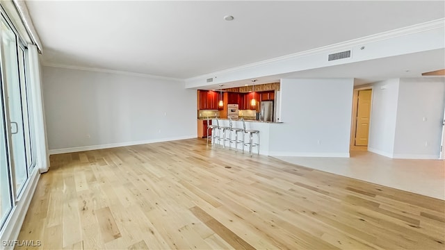 unfurnished living room featuring light hardwood / wood-style flooring and crown molding