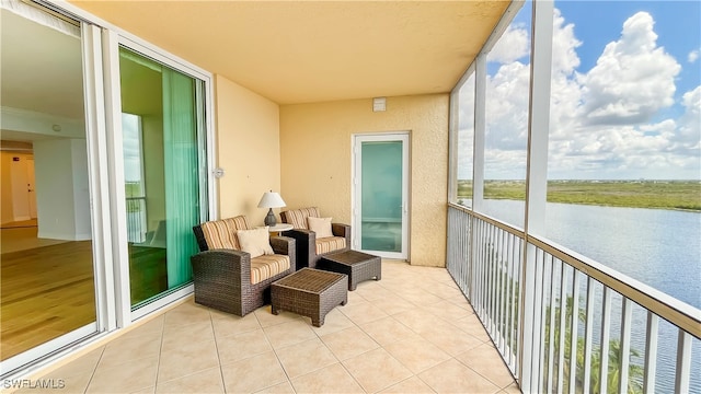 sunroom featuring a water view