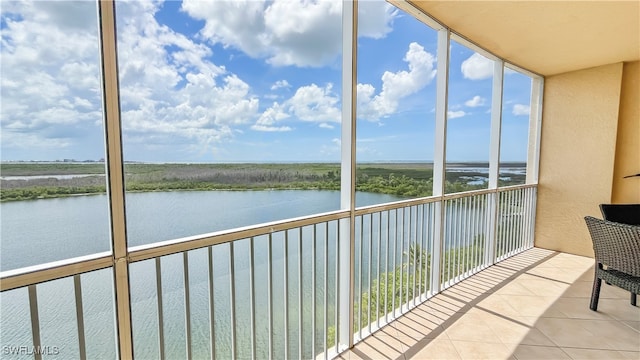 unfurnished sunroom featuring a water view