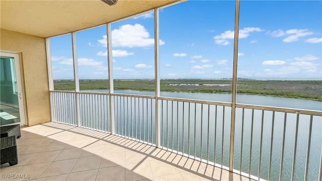 unfurnished sunroom featuring a water view