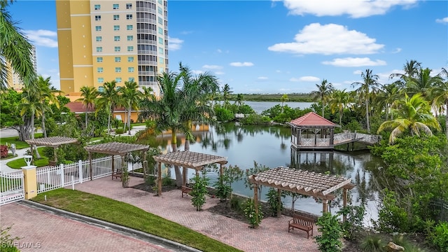 view of dock with a water view and a pergola