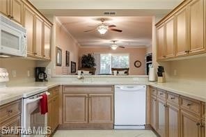 kitchen with ceiling fan, white appliances, and kitchen peninsula