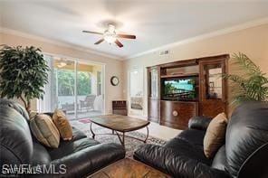 living room with crown molding and ceiling fan