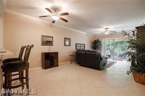 living room with ceiling fan, ornamental molding, and light tile patterned flooring