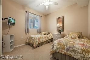 bedroom featuring ceiling fan and carpet