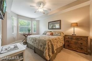 bedroom featuring ceiling fan and light carpet