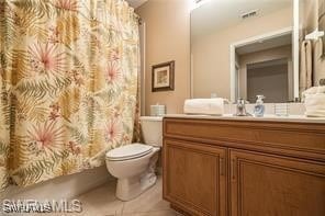 bathroom with vanity, toilet, tile patterned floors, and walk in shower