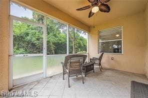 sunroom featuring ceiling fan and a healthy amount of sunlight