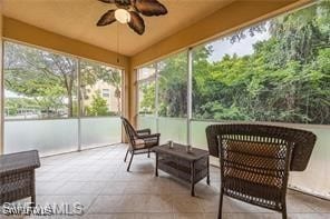 sunroom / solarium featuring ceiling fan