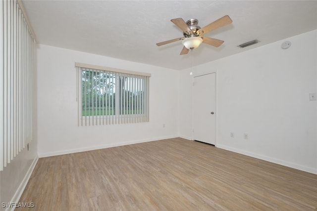 unfurnished room with ceiling fan and light wood-type flooring