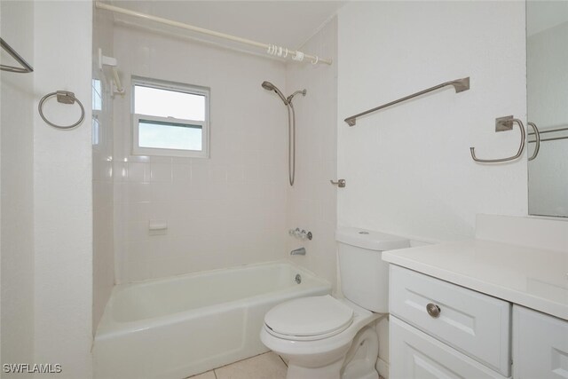 full bathroom featuring tile patterned floors, vanity, toilet, and tiled shower / bath combo