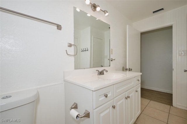 bathroom with vanity, tile patterned floors, and toilet