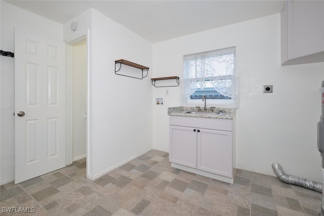 washroom with cabinets, electric dryer hookup, sink, and washer hookup