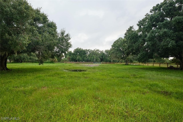 view of yard with a rural view