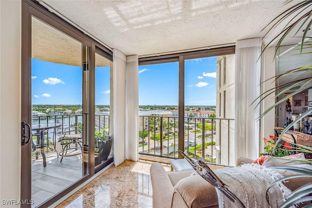 unfurnished sunroom with a water view