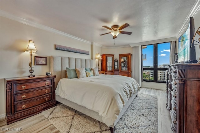 bedroom featuring ceiling fan, ornamental molding, and light hardwood / wood-style floors