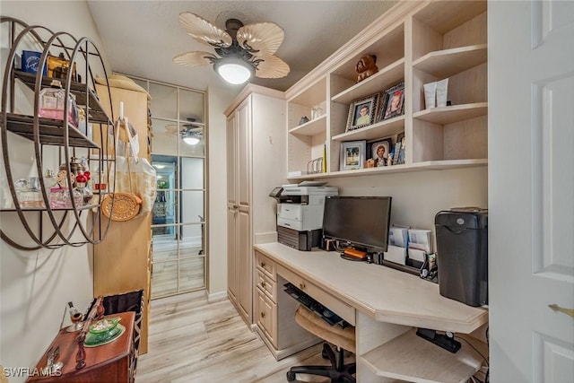 home office with ceiling fan and light hardwood / wood-style floors