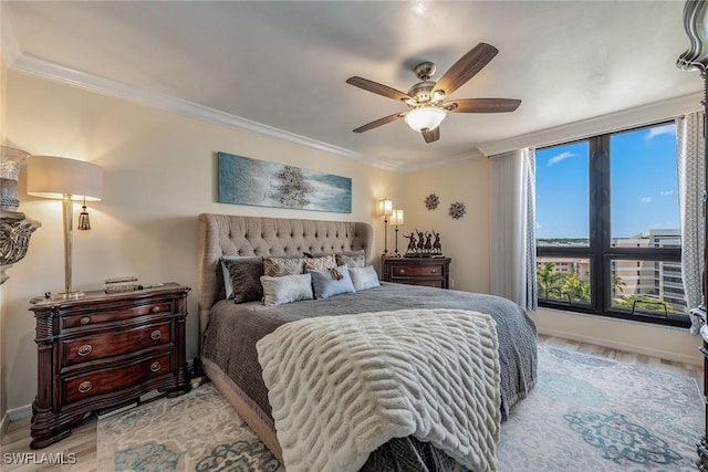 bedroom featuring crown molding, light hardwood / wood-style flooring, and ceiling fan