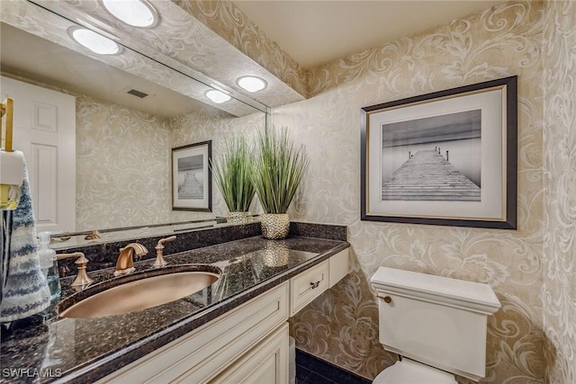 bathroom featuring vanity and toilet