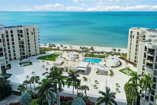 aerial view with a water view and a beach view