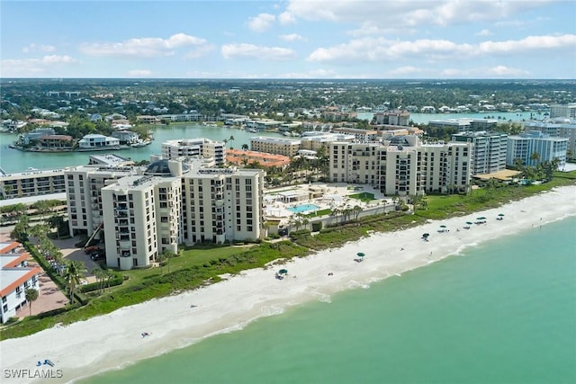 drone / aerial view featuring a water view and a view of the beach