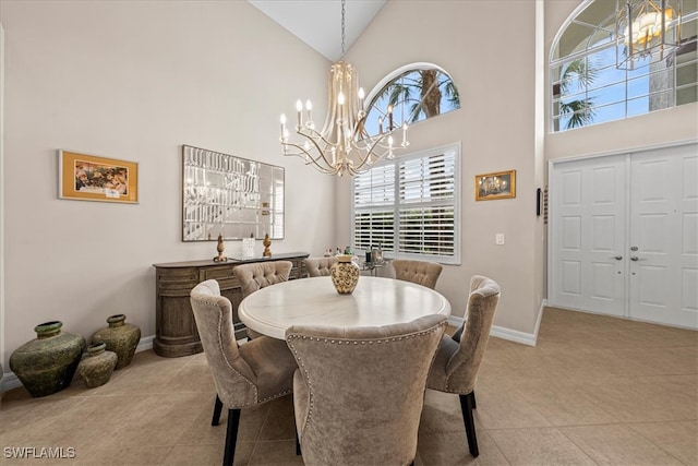 dining area featuring high vaulted ceiling, light tile patterned floors, and an inviting chandelier