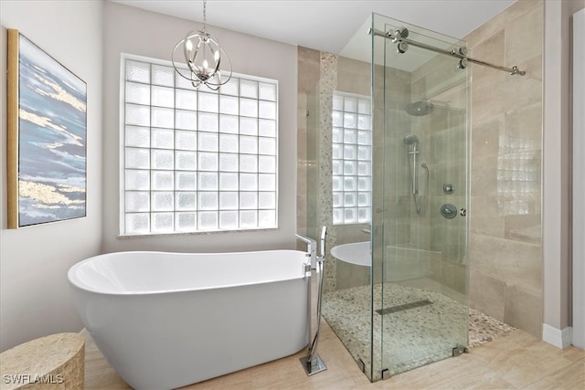 bathroom featuring tile patterned flooring, shower with separate bathtub, and a healthy amount of sunlight