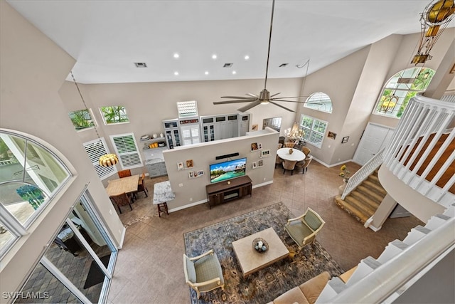 living room featuring ceiling fan and high vaulted ceiling