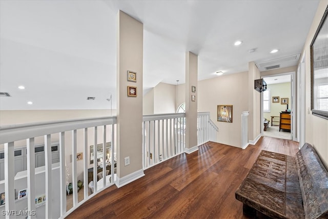 hallway with lofted ceiling and wood-type flooring