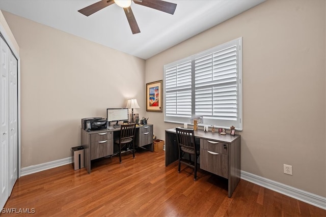 home office with ceiling fan and light hardwood / wood-style flooring