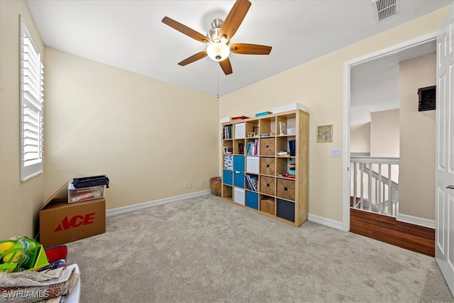 misc room with light carpet and ceiling fan