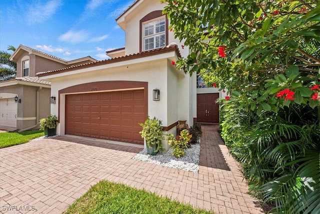 mediterranean / spanish-style house with a garage