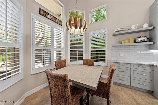 dining space with light tile patterned flooring and a healthy amount of sunlight