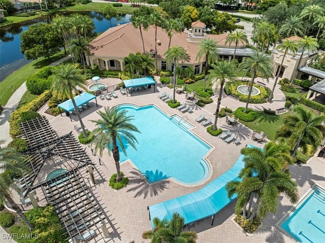 view of pool with a water view and a patio area