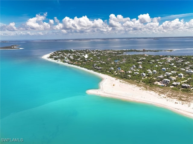 birds eye view of property featuring a water view and a view of the beach