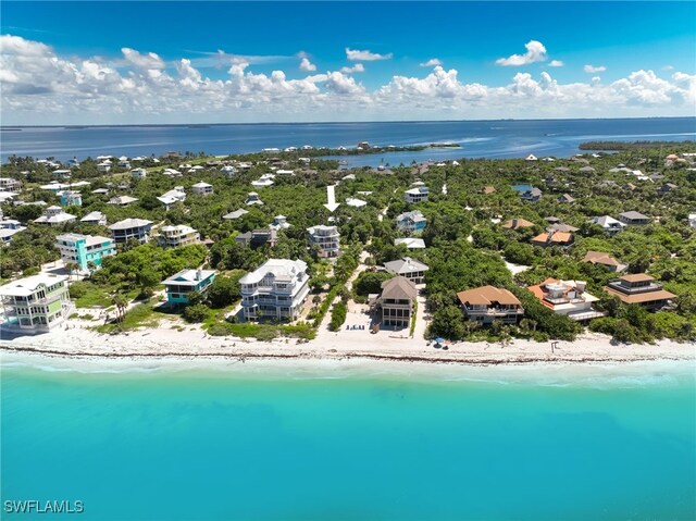 aerial view with a water view and a beach view