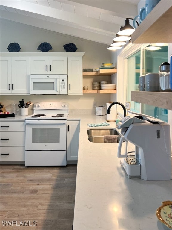 kitchen with hardwood / wood-style floors, white appliances, lofted ceiling with beams, sink, and white cabinetry