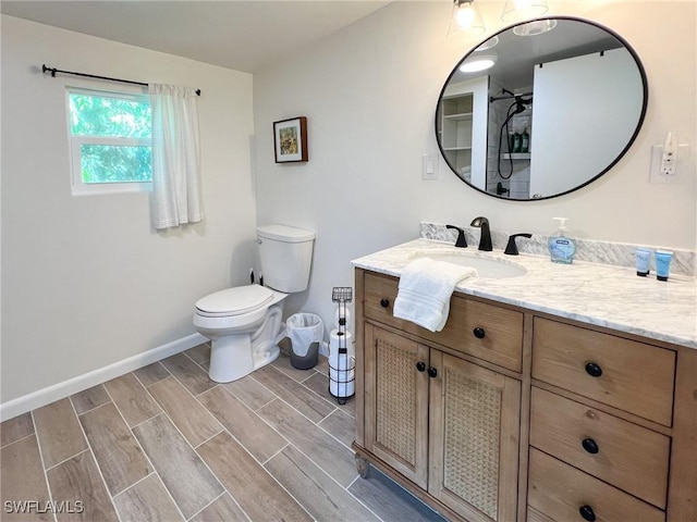 4570 Escondido Ln, Upper Captiva, FL 33924 - bathroom with vanity, baseboards, wood finish floors, and toilet