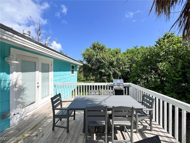 wooden deck with a grill