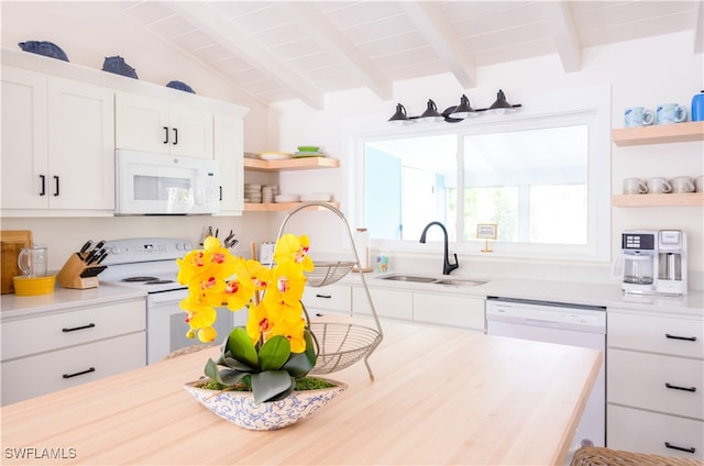 kitchen with vaulted ceiling with beams, white appliances, white cabinetry, and sink