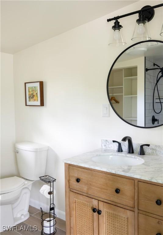 4570 Escondido Ln, Upper Captiva, FL 33924 - bathroom featuring toilet, vanity, tile patterned flooring, and baseboards