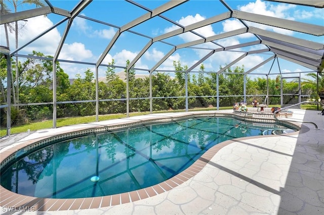 view of pool featuring a patio and glass enclosure