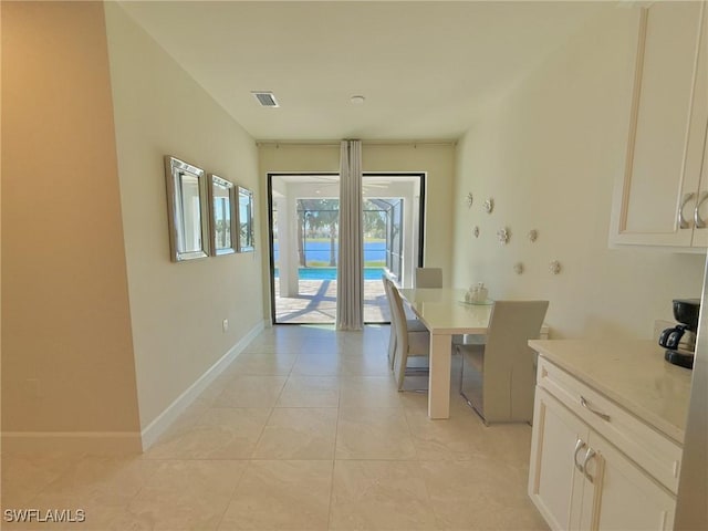 unfurnished dining area with light tile patterned flooring