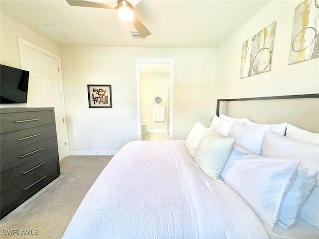 bedroom with ensuite bath, ceiling fan, and carpet floors