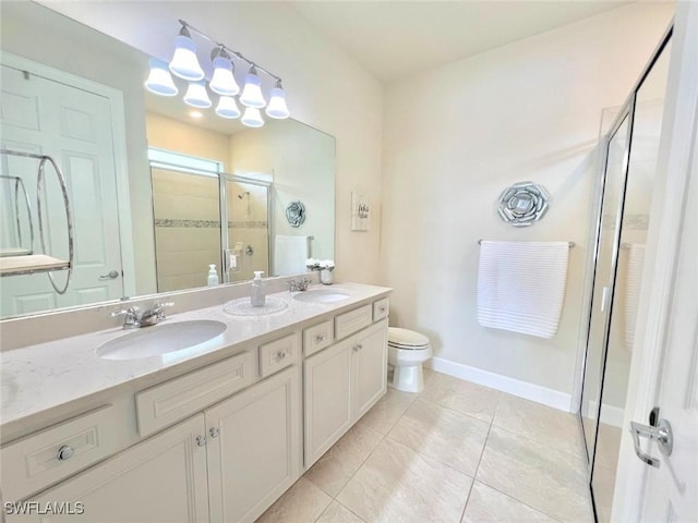 bathroom featuring toilet, a shower with door, vanity, and tile patterned flooring