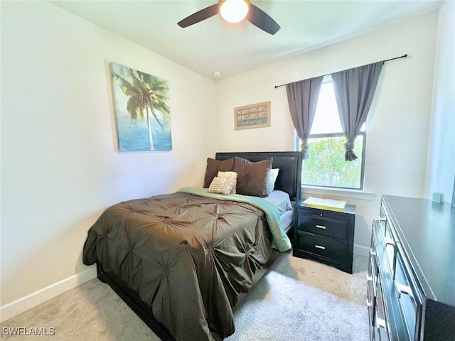 bedroom with ceiling fan and light carpet