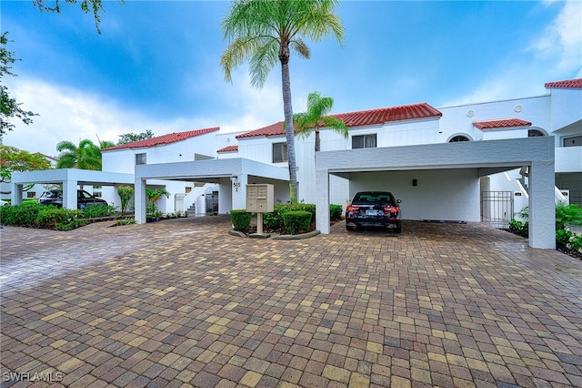 mediterranean / spanish home featuring a carport